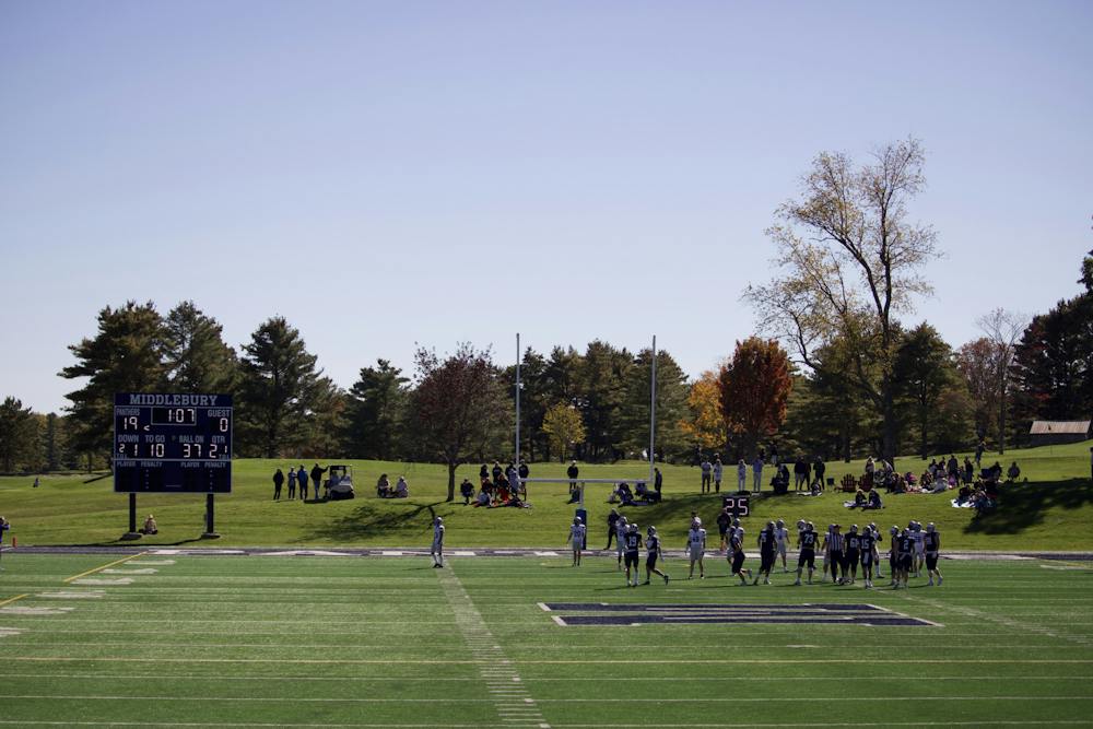 Middlebury football takes on Colby, framed by Vermont fall foliage.