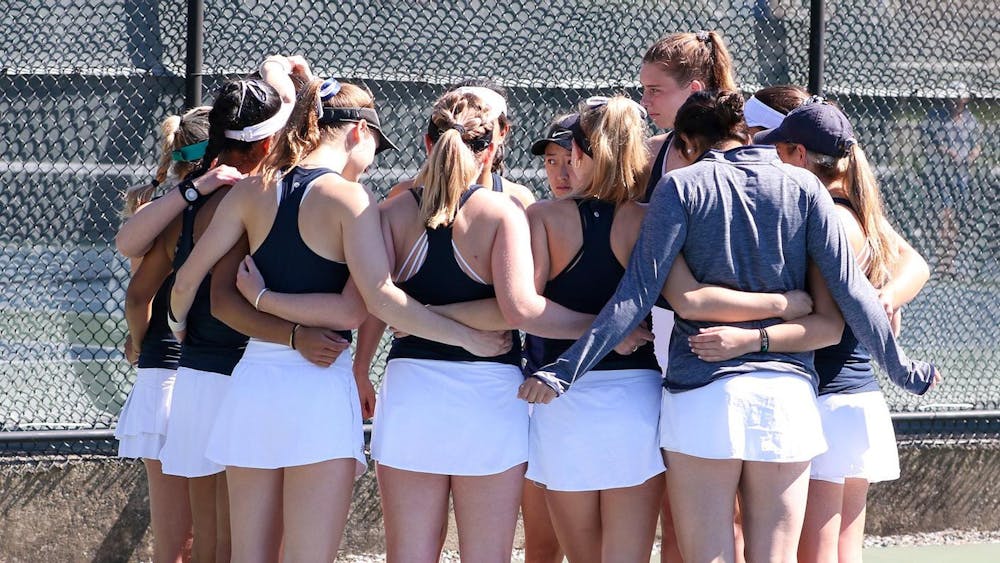 The women’s tennis team huddles together before NCAA regionals.