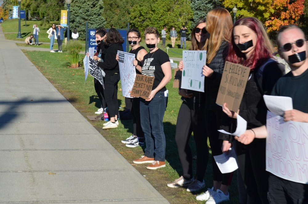 <span class="photocreditinline"><a href="https://middleburycampus.com/39367/uncategorized/benjy-renton/">BENJY RENTON</a></span><br />Students look onto the parade, protesting in peaceful silence.