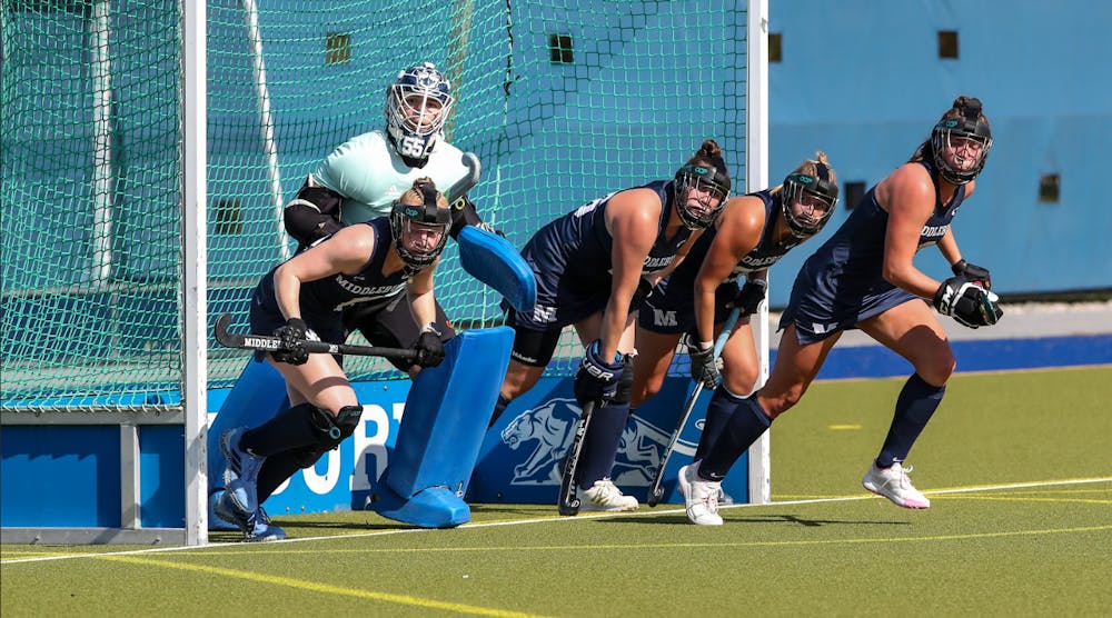 Izzy Redzic ’27 and Middlebury’s penalty corner unit on defense against Bowdoin.