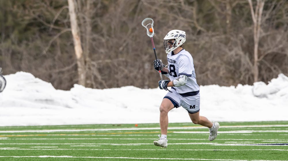 William Munroe ’25 carries the ball in the lacrosse team’s 18–15 win over Babson