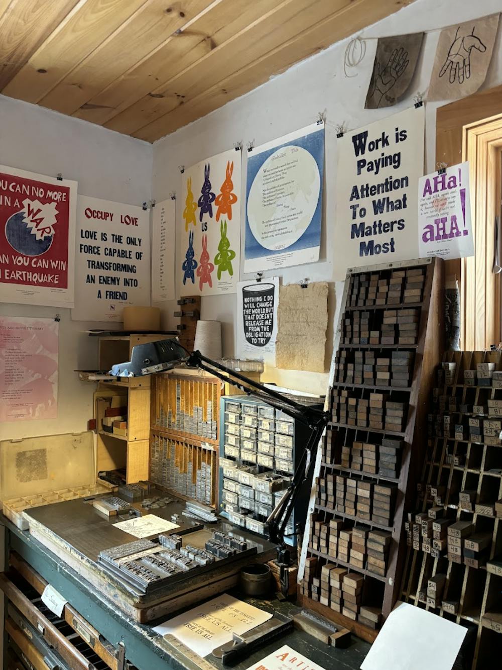 John Vincent crafts Revolutionary Press materials at his studio in New Haven, a colorful space brimming with different types, card stock and prints.