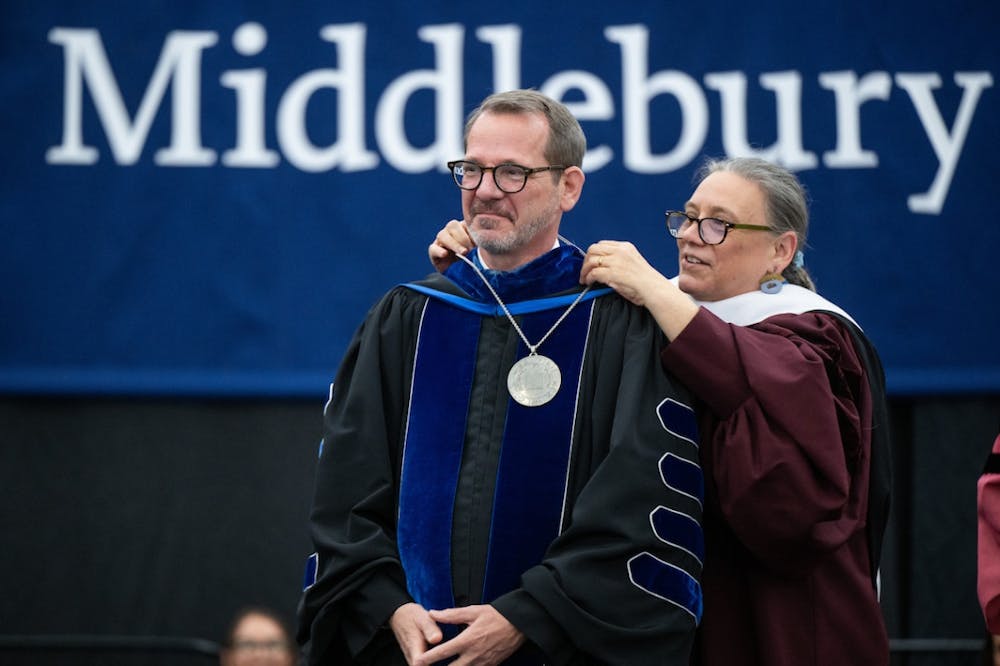 Former president Laurie Patton places the official college medallion around President Baucom's neck during the ceremony.