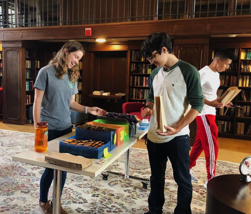 <span class="photocreditinline">COURTESY OF NIKI KOWSAR</span><br />Peer sex educator Ella Houlihan ’21 greets first-year students at workshop table.