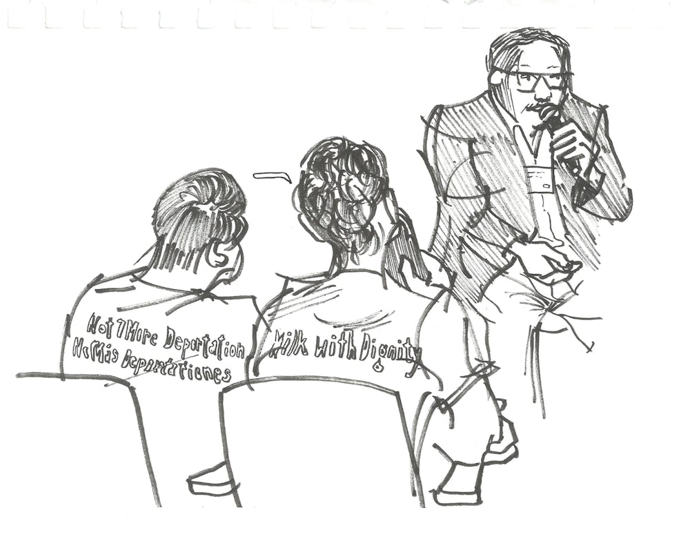 Migrant Justice organizer Will Lambek live translates English panels into Spanish for organizer "Kike" Balcazar.