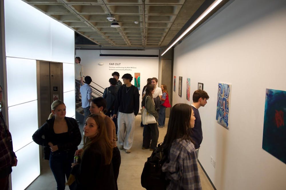 Gallery-goers take in Mark McGoey '26.5's new visual arts exhibit, "Far Out".