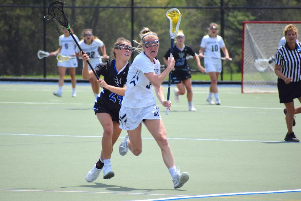 <span class="photocreditinline"><a href="https://middleburycampus.com/39367/uncategorized/benjy-renton/">BENJY RENTON</a></span><br />Jane Earley '22 rushes past a Franklin and Marshall defender during the NCAA Regional Final on Sunday, May 19.