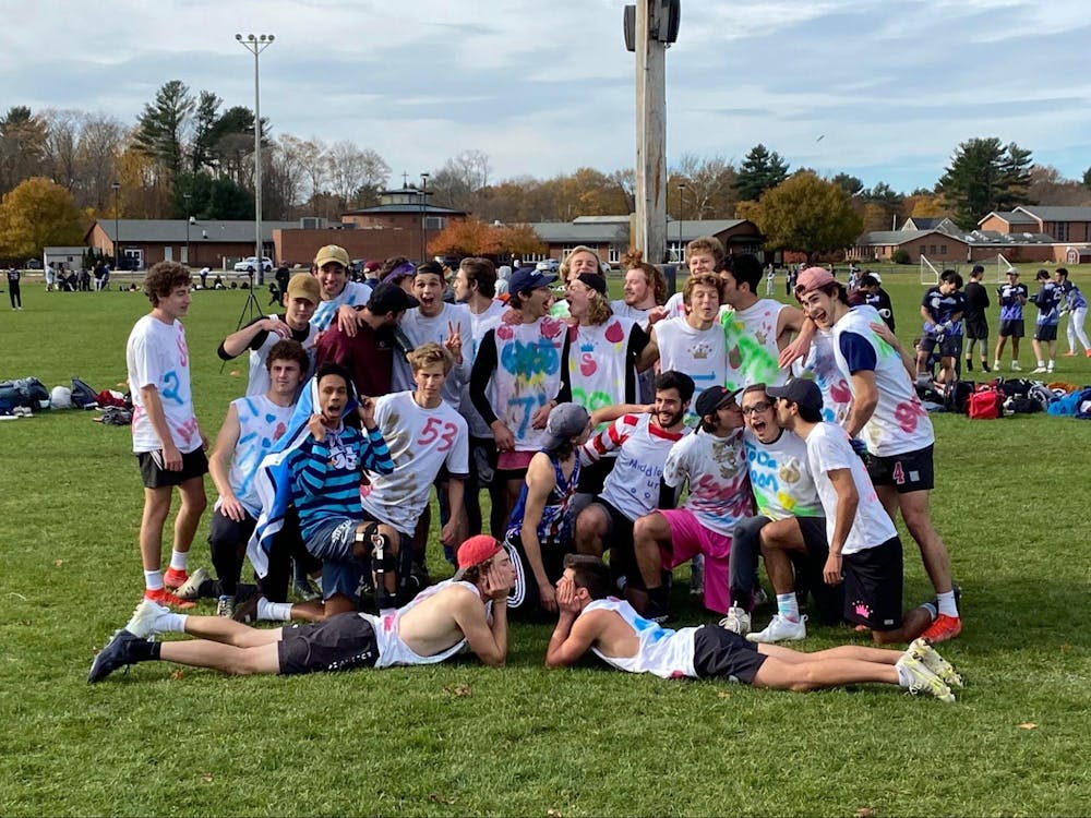 The men’s ultimate frisbee team poses after their victory at New England Regionals. (Courtesy of Austin Dahl)