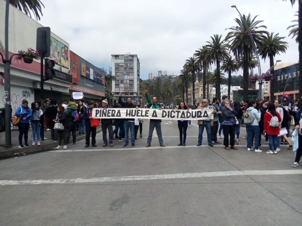 <span class="photocreditinline">COURTESY OF MASON ARNDT</span><br />Protesters carrying a banner bearing the slogan “Piñera smells like dictatorship” gathered in Valparaíso, Chile Wednesday morning.