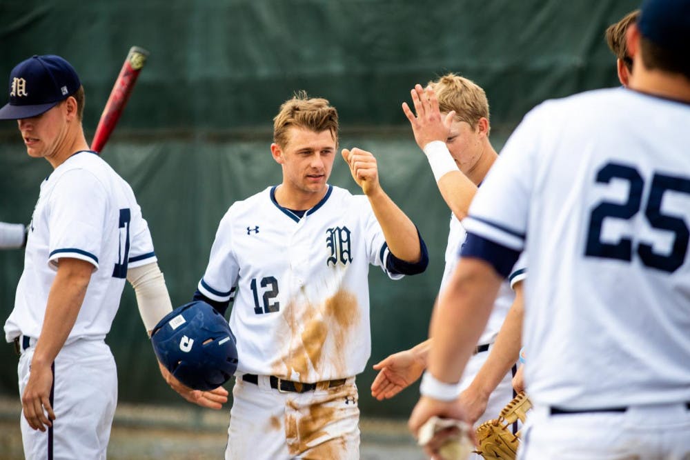 <span class="photocreditinline"><a href="https://middleburycampus.com/39670/uncategorized/michael-borenstein/">MICHAEL BORENSTEIN</a></span><br />Brooks Carroll ’20 cools off with teammates after going 2-for-3 with a game-high of five RBIs.