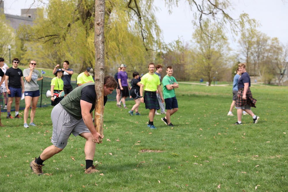 Thomas Perry ’25 competes in the caber toss at the 2023 Middland games.