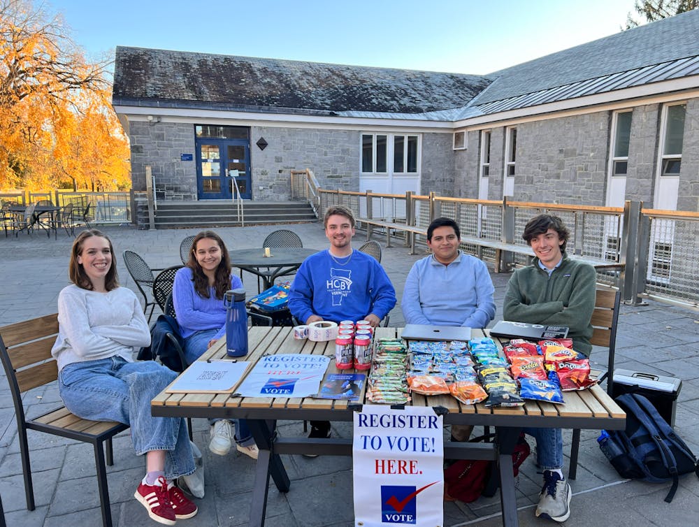 MiddVotes volunteers tabling outside of Proctor Dining Hall.