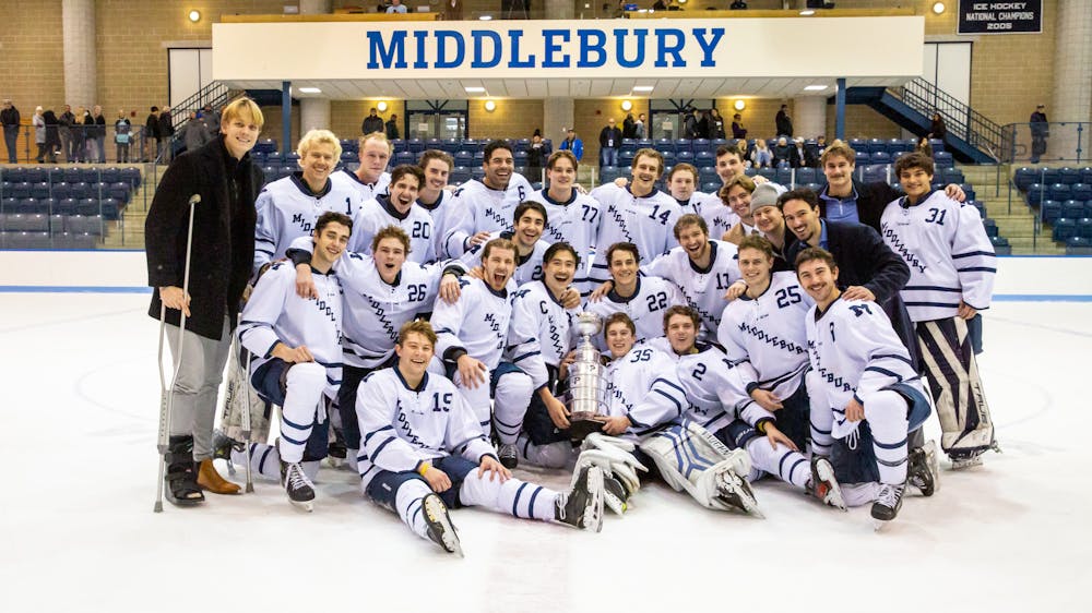 Middlebury men's hockey team poses after a win.