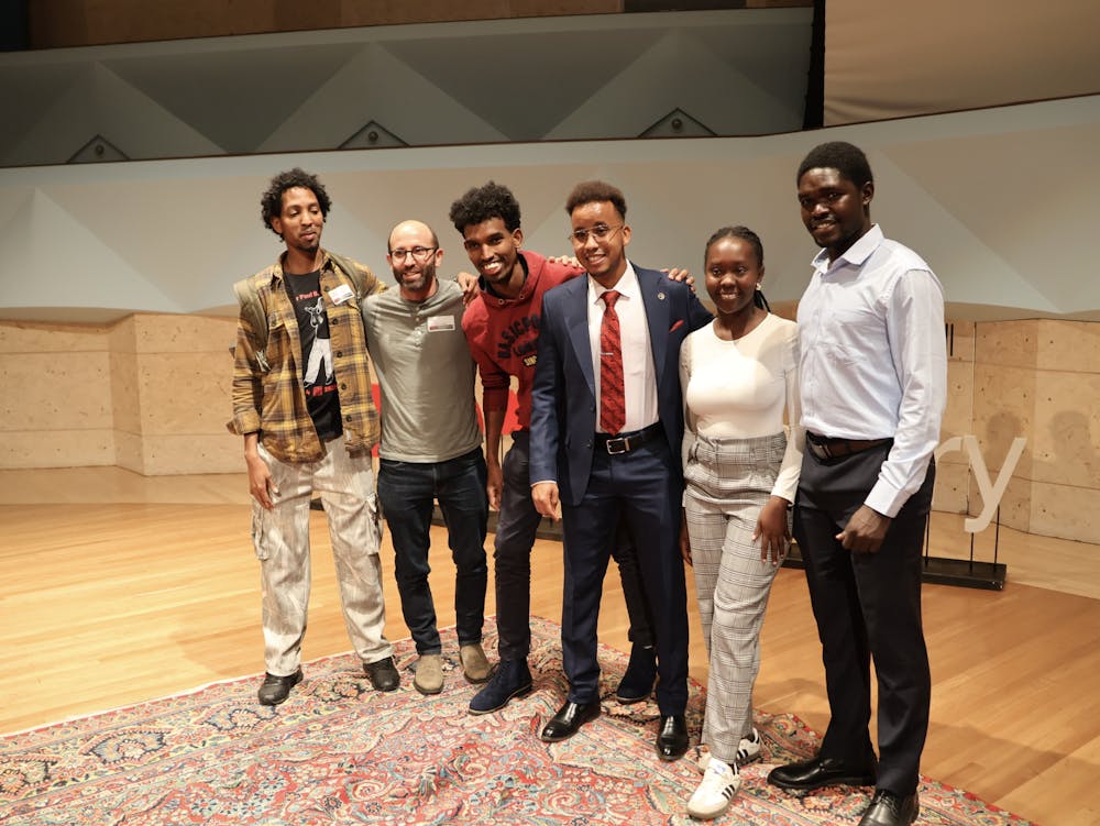 Director Alan Davidson (second from left), Mohamed Noor '27 (fourth from left), Emmy Napao '26 (fifth from left) and two other KenSAP alumni at last fall's TedX event. Noor was the student speaker and discussed his journey to Middlebury, including KenSAP.