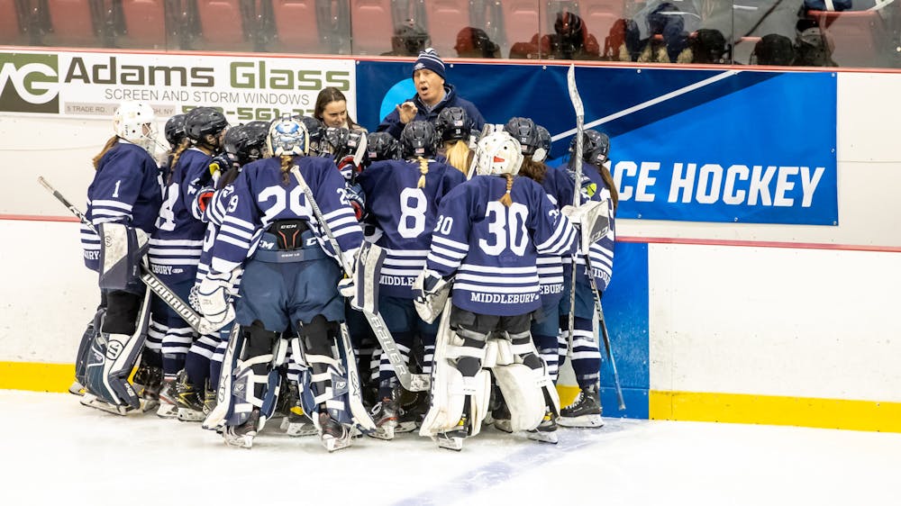 <p>Mandigo coaches his team in the huddle. </p>