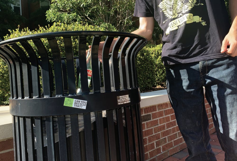 A student throws away a bottle on campus.