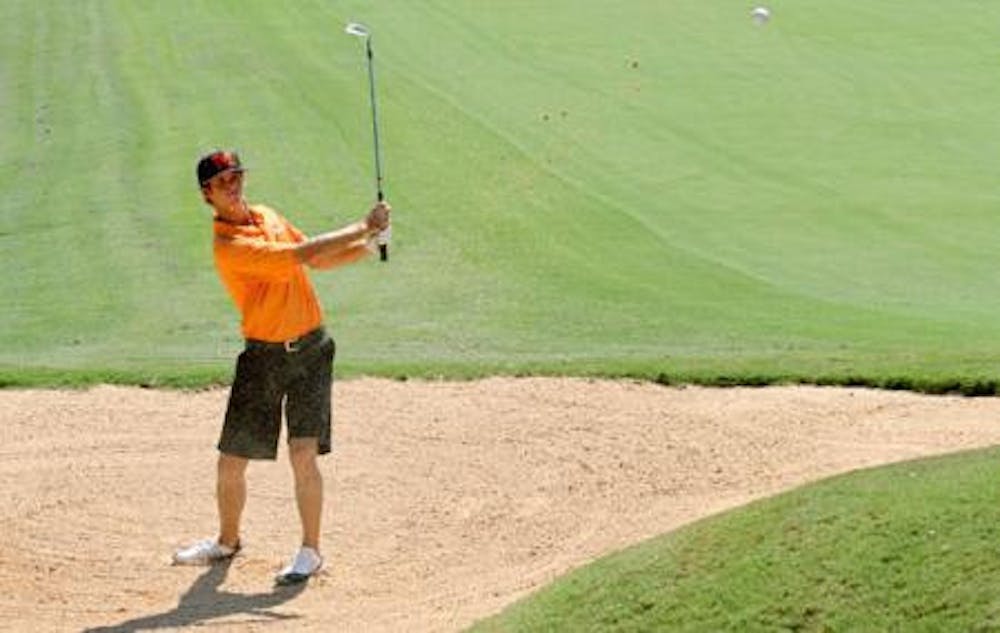 (photo courtesy of MercerBears.com) Mercer's Josh Cone attempts to get out of the sand, helping the Bears score well in the first round with a even-par 72.