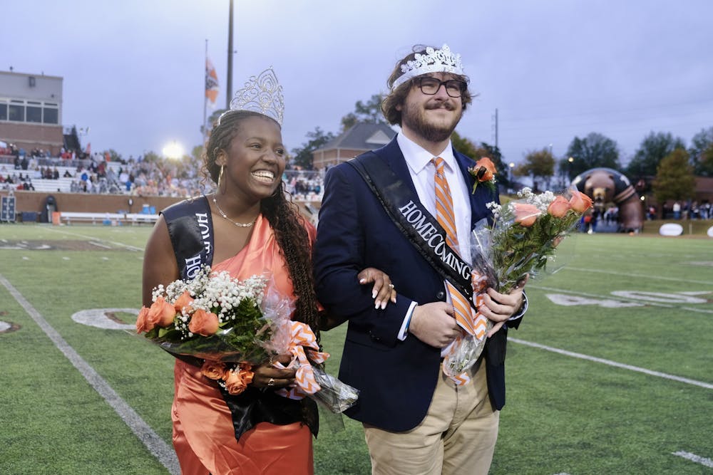 <p>Ashton Mayo-Beavers &#x27;24 and Benjamin Smith &#x27;24 walk off the field after being crowned Homecoming queen and king at halftime.</p>