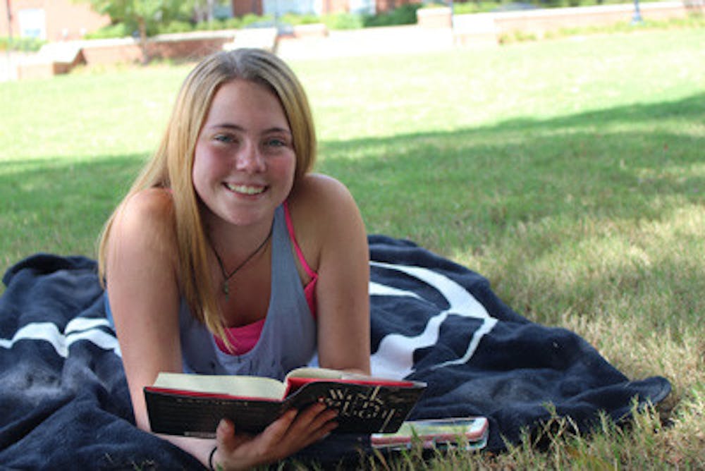 Freshman Alyssa Lorenzen reads out on Cruz Plaza after taking her psychology exam. "I'm hoping for the best," she said.