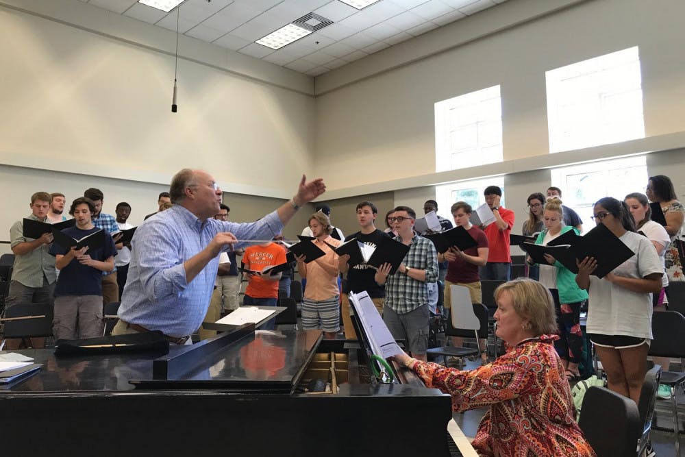 Mercer Singers rehearse for the upcoming Family Weekend concert under the direction of Stanley Roberts.