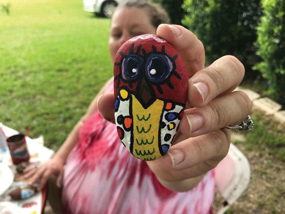 A member of the popular "Macon GA Rocks" Facebook page holds her freshly painted rock.