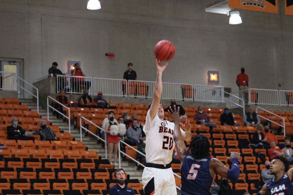 Mercer's Ross Cummings (#20) shoots over Samford's A.J. Stanton-McCray (#5). Cummings would make the shot to go toward his game high, 25 points, which propelled Mercer to an 89 to 82 victory over Samford in double overtime Feb. 8.