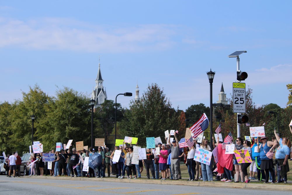 Protestors line the College Street-side of Tattnall Square Park on Saturday, Oct. 18, 2025, less than a quarter-mile from Mercer's campus. The "No Kings" protest drew about 300 people.