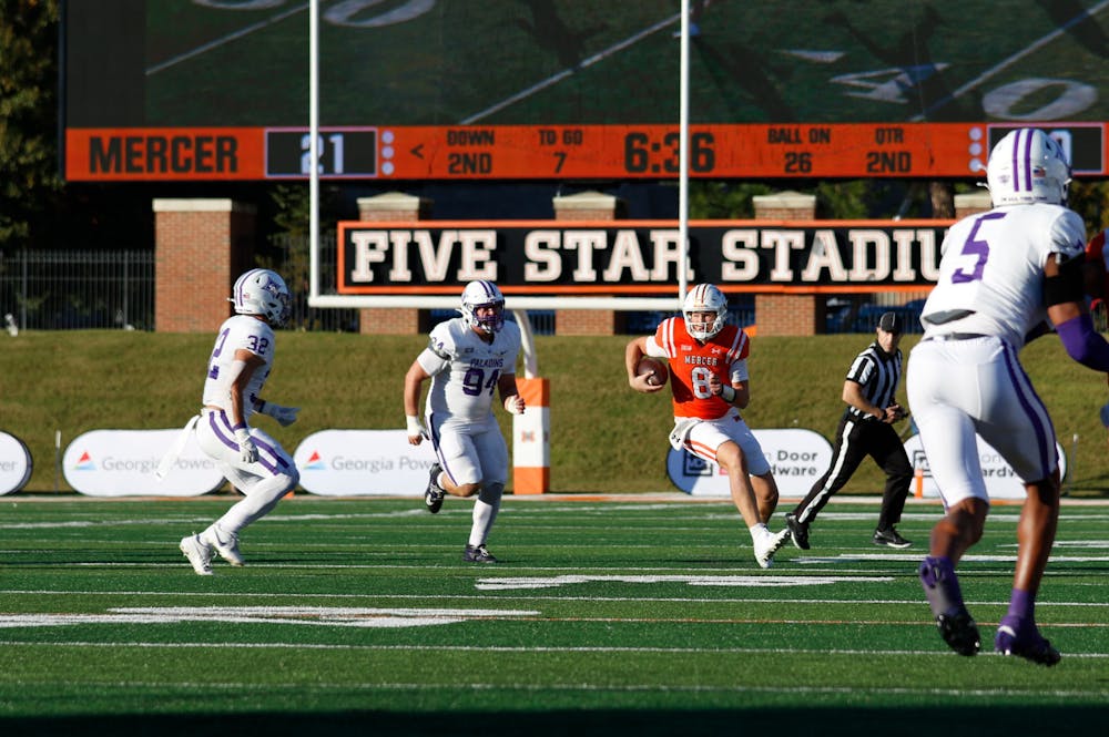 Whitt Newbauer '28 carries the ball against Furman University as Mercer beat the Paladins to capture their first Southern Conference title. Newbauer, a true freshman quarterback, was named to the SoCon All-Freshman team.