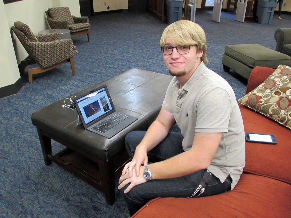 Freshman Devin Prather reads a summary of the second 2016 Presidential Debate in Jack Tarver Library.