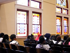 Students listen to Sheknita Davis give a keynote address inside Willingham Auditorium. 