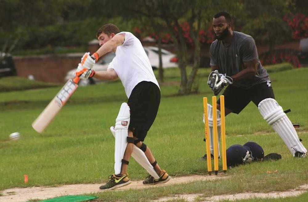 ANNA VATAGINA/THE CLUSTER
Macon, Georgia, 09/16/15:
Co-captain Samuel Brunk is up to bat in a game of cricket with Richie Edmondson catching.