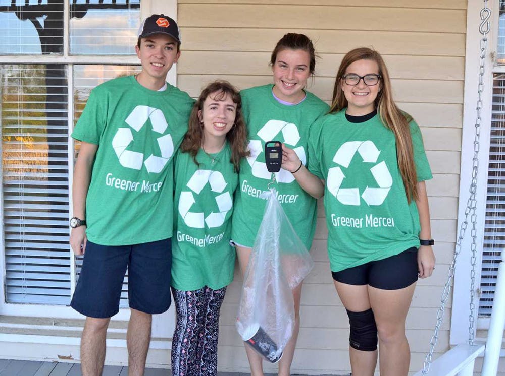 (From Left to Right) Trent Bateman, Anna Dillon, Jessie Lewis, and Katelyn West help weigh some trash while working on a project for Greener Mercer.