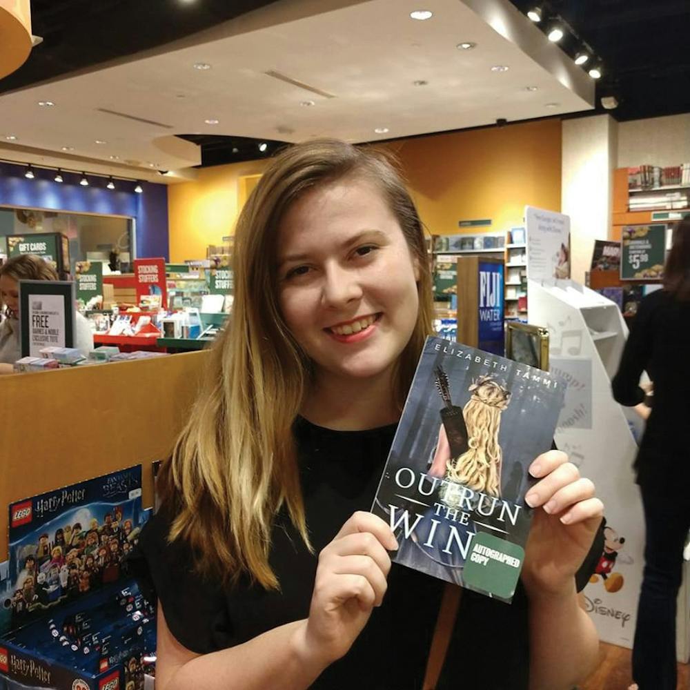 Mercer Creative Writing alum, Elizabeth Tammi, pictured with her first novel, “Outrun the Wind.” Photo provided by Elizabeth Tammi.