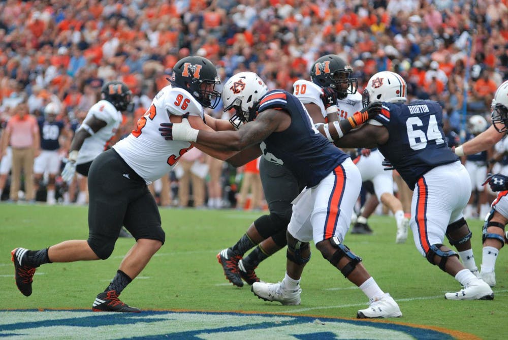 Destin Guillen and Behr Cooper work to defend the play by Mercer during the Mercer vs. Auburn game at Auburn University.