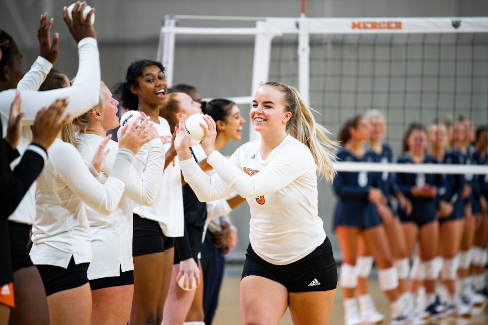 <p>Members of Mercer&#x27;s volleyball team celebrate during an Aug. 27 match against the University of New Hampshire at Hawkins Arena in Macon, Georgia.</p>