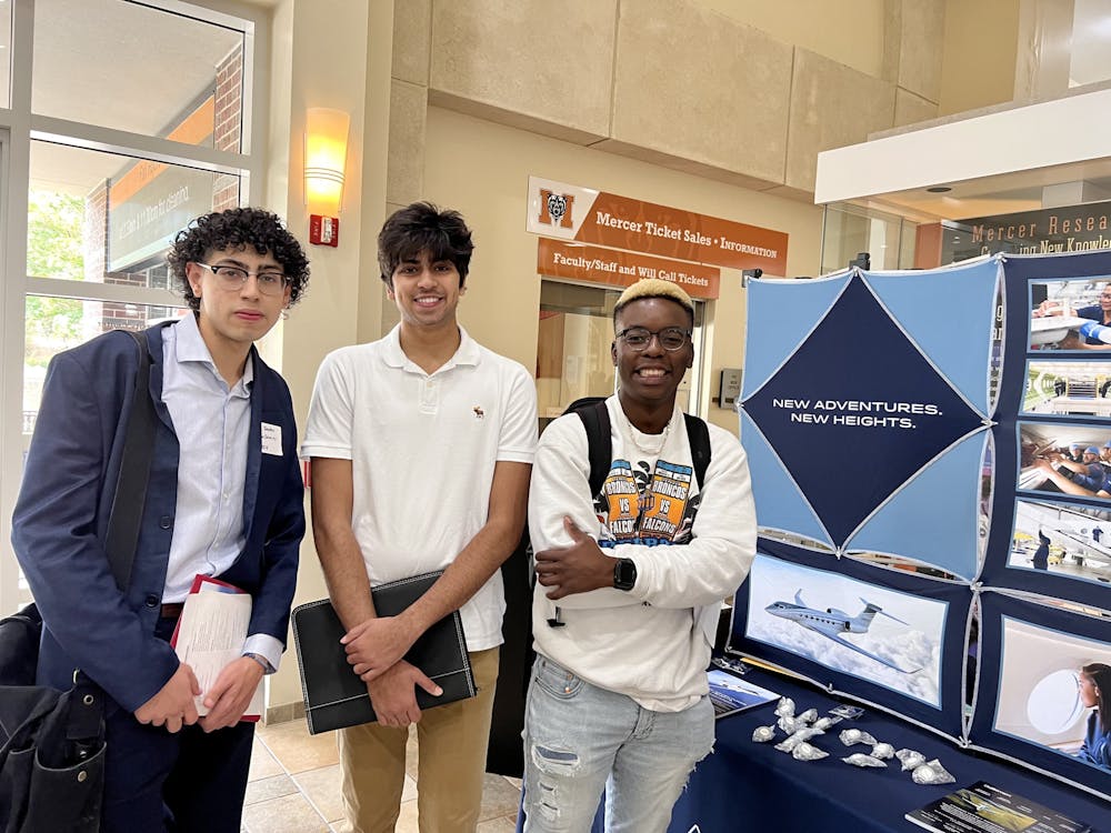 <p>Jay Sanchez, Muhammed Shafiq and Themba Nsubuga attend the Job and Internship Career Expo in the University Center on Sept. 28, 2022.</p>