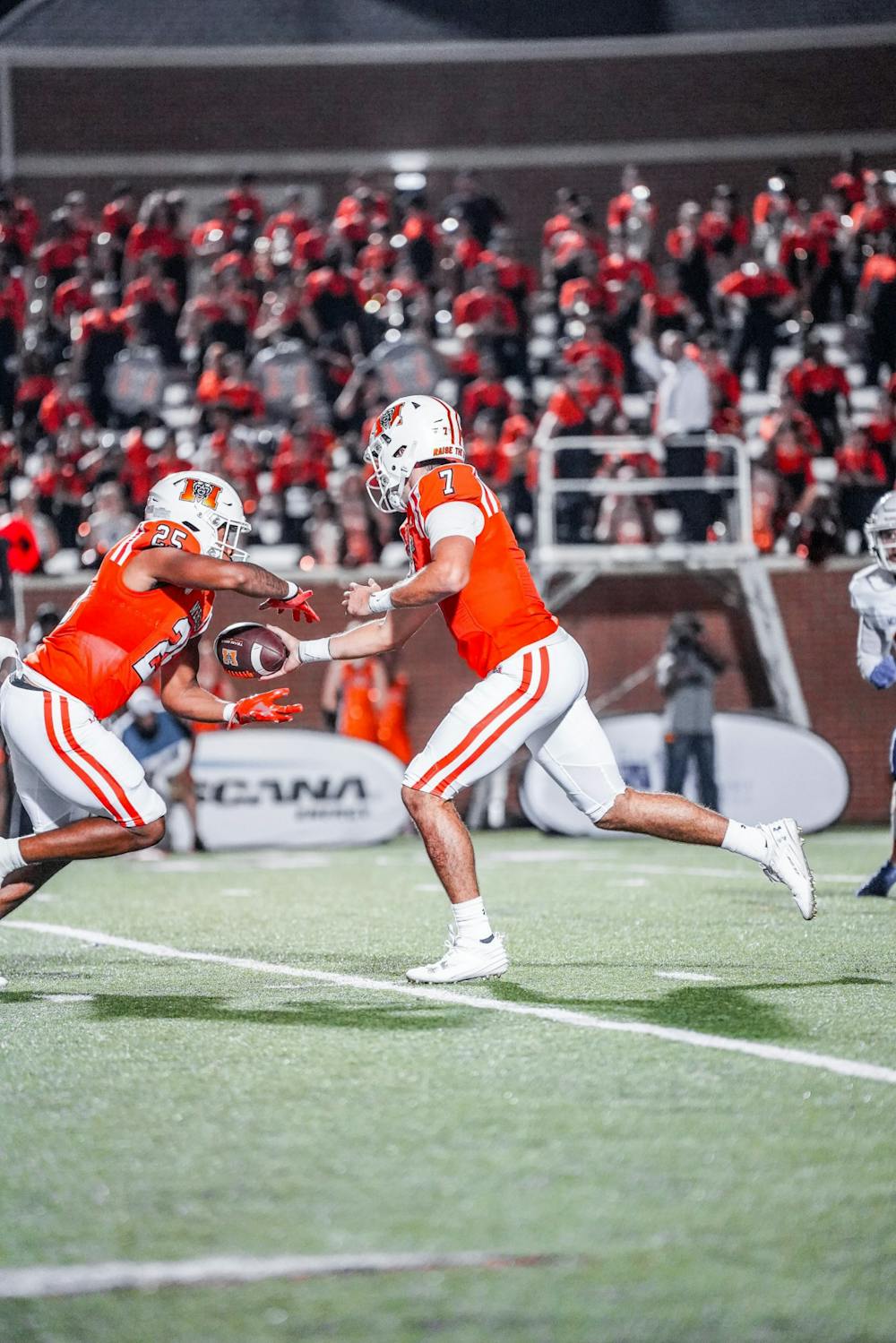 <p>Carter Peevy &#x27;26 hands the ball off to ﻿Tyrell Coard &#x27;27 in Mercer&#x27;s win against Morehead State on Saturday. Coard scored his first career touchdown in the game, which ended 48-22 for the Bears.</p>