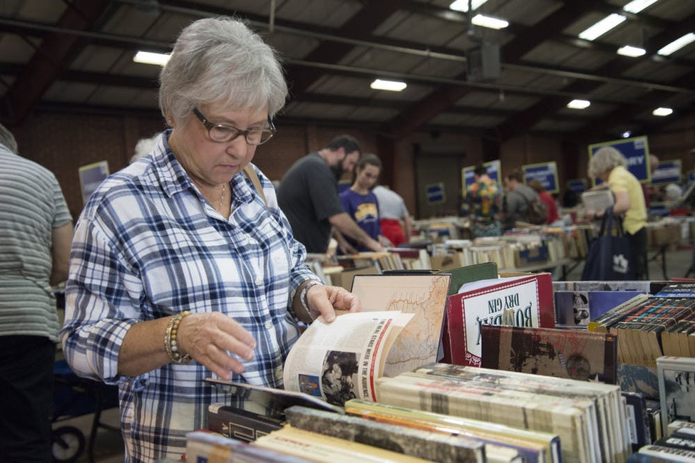 Ken Bryant flips through a book called "1492: Into the Battle" in the military section of The Old Book Sale on Thursday, March 1. The event will continue through Sunday, March 4. The hours of operation are 10 a.m. to 7 p.m. on Friday, 10 a.m. to 5 p.m. on Saturday and noon to 5 p.m. on Sunday. According to the Friends of the Library website, there will be over 100,000 books in 75 different categories at the event.