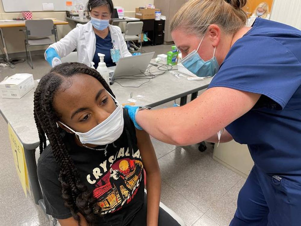 An Atrium Health Navicent staff member gives a COVID-19 vaccine to Bibb County student. The vaccination event was part of a partnership between the county school district, Atrium, the state health department and Macon-Bibb County. Photo provided by The Macon Telegraph. 

Read more at: https://www.macon.com/news/local/education/article252375438.html#storylink=cpy
