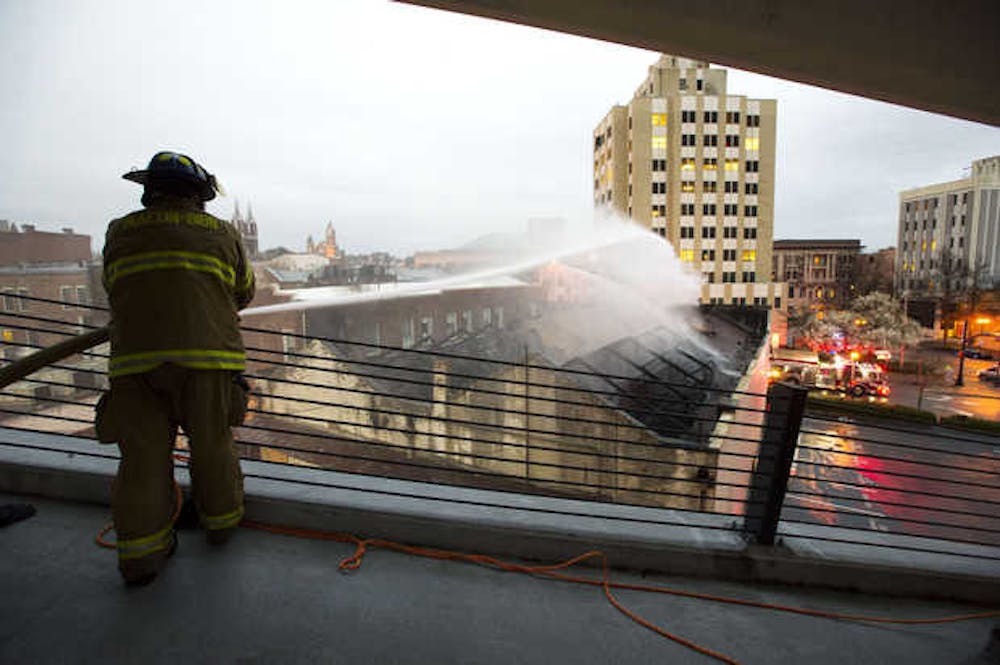 Macon-Bibb firefighters attempt to hold back the blaze that took down the historic Nu-Way Weiner restaurant in downtown Macon.