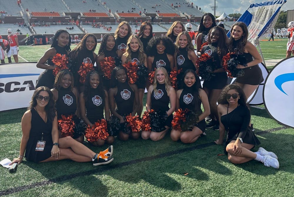Mercer's 2025 dance team poses on the sideline of a Mercer football game.