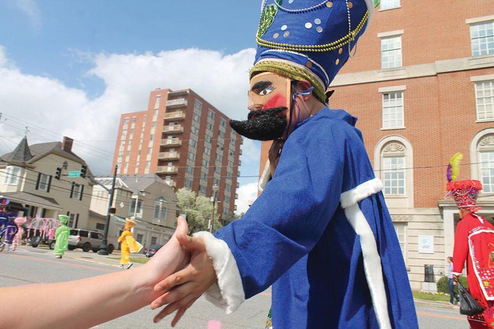 People in costumes make their way down to Cherry Street during last year’s Cherry Blossom parade.