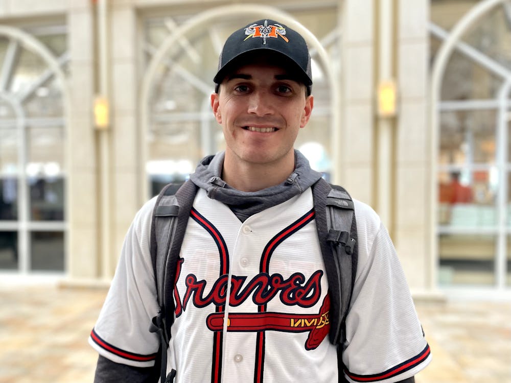 Senior Matthew Martin poses for a portrait in his Atlanta Braves jersey Wednesday. Martin was one of many Mercer students who wore their Braves gear to class following the team's win. 