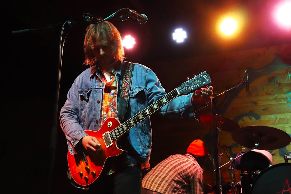 <p>Lead singer of the headlining band Ashes, Lewis Ashe &#x27;23 tuned his guitar in preparation for the band’s performance at Bonnamu on Oct. 29, 2025. Ashe is a Mercer Alpha Tau Omega alumnus.</p><p></p>