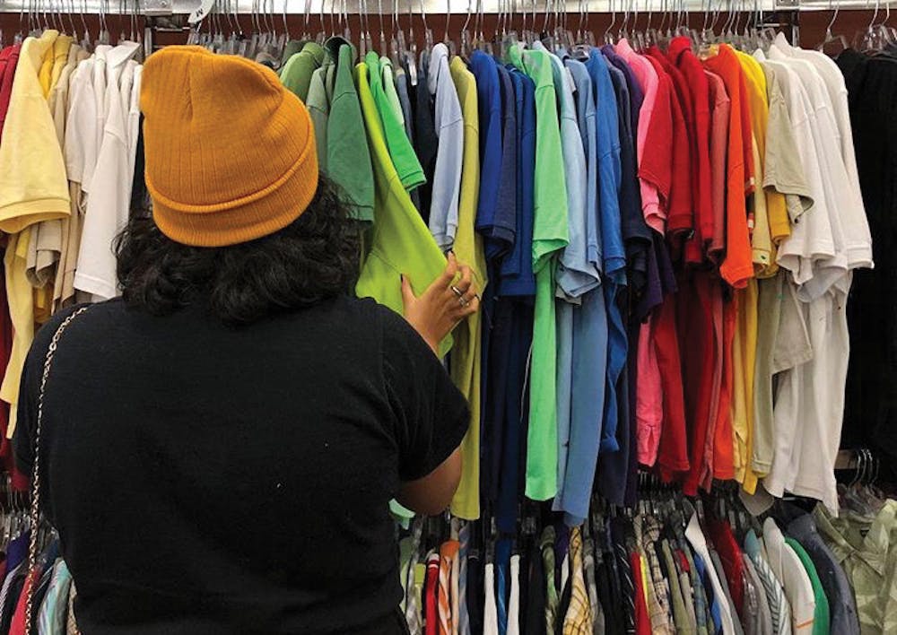 Sanaa Yusuf sifts through the clothes at Goodwill.