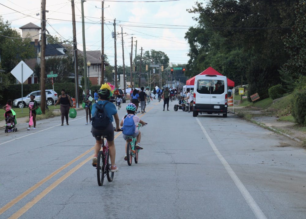 <p>Participants in Open Streets Macon ride down Monroe Street on Sep. 28.</p>