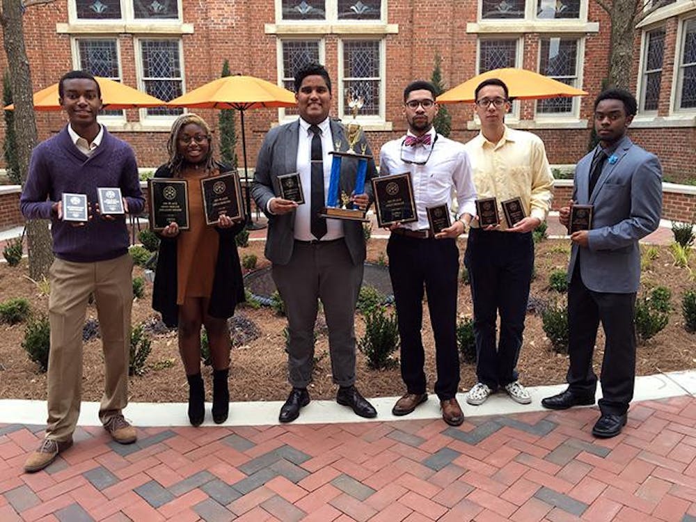 Mercer Debate team shows off trophies from 2015-2016 season.