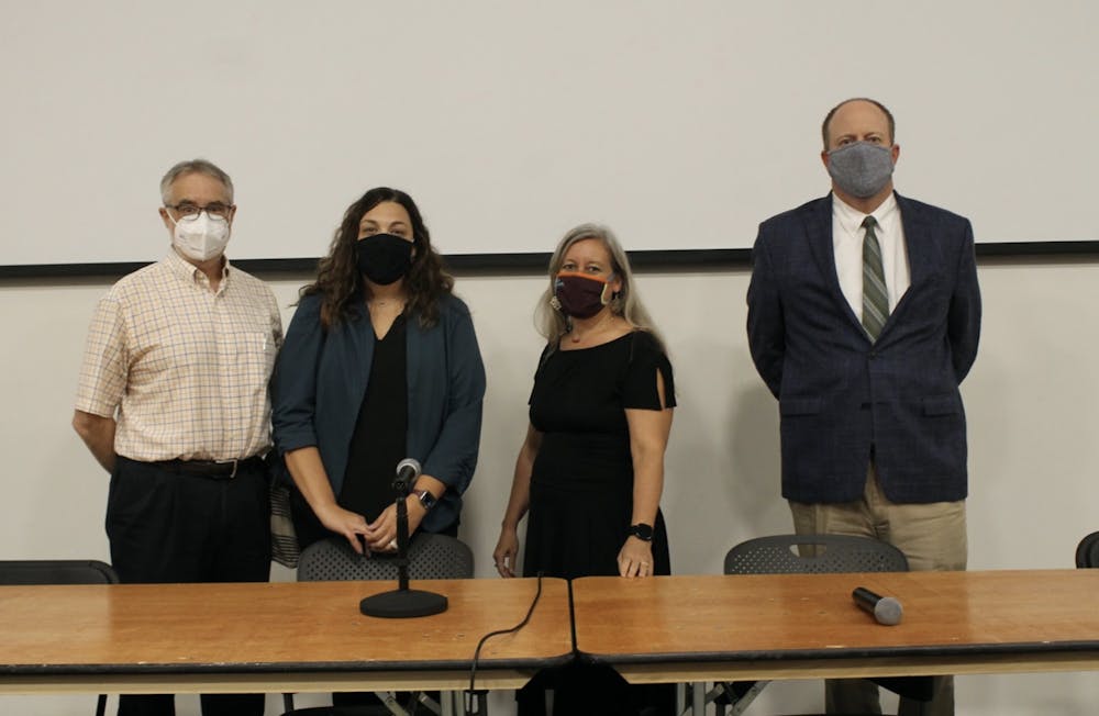 <p>From left to right, Paul Lewis, Laura Simon, Amy Nichols-Belo and Will Jordan pose for a picture as they prepare to debate about a possible vaccine mandate in Willet Auditorium on Oct. 26, 2021.</p>