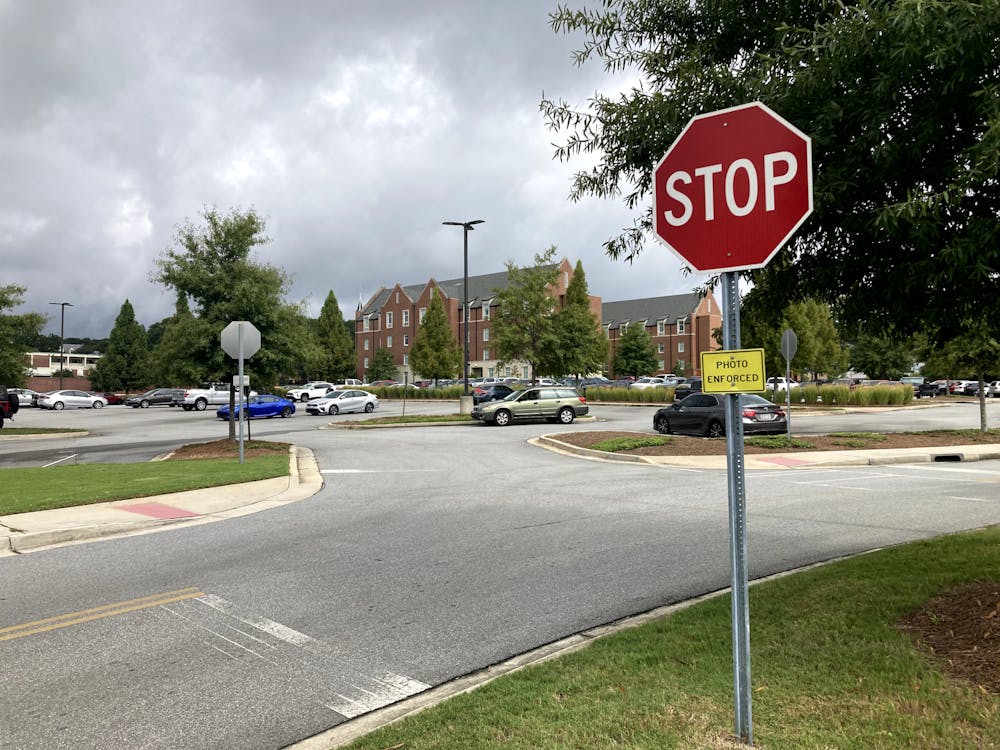 <p>“PHOTO ENFORCED” notices were added to the stop signs between first year residence hall parking and the medical school parking lot in April. Auxiliary Services staff felt as though they were in danger from drivers disregarding the traffic laws at the intersection.</p>