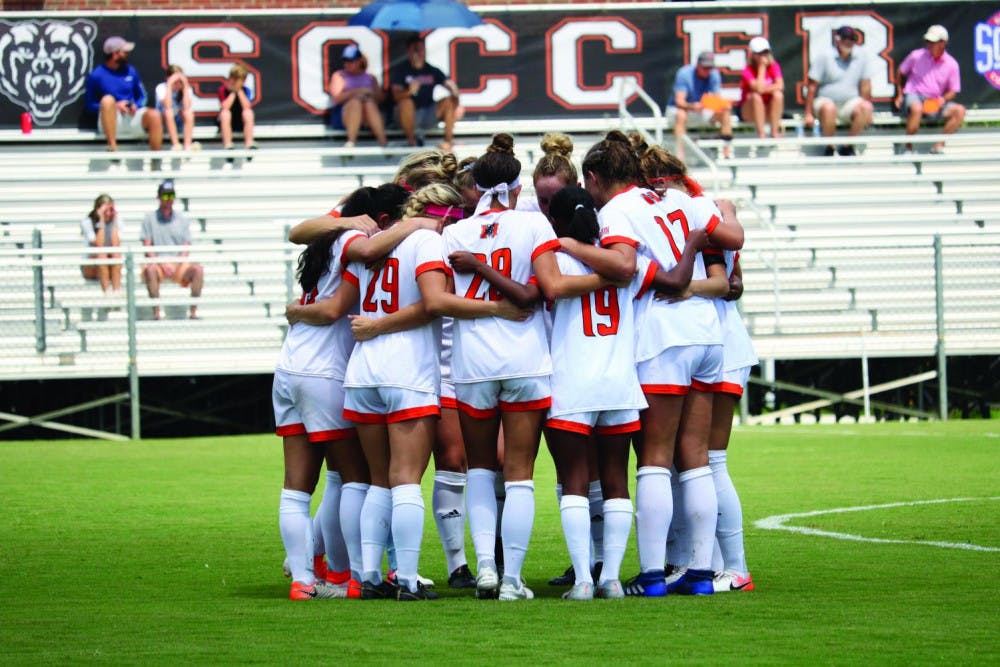 The Mercer Women’s Soccer Team huddles together during a game.